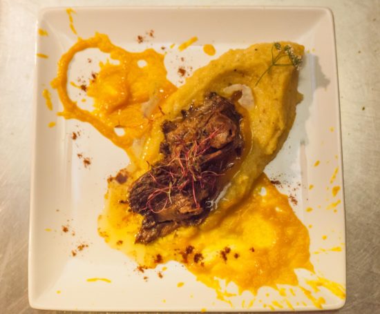 Braised Lamb with Crucian Spice Polenta. Image Courtesy of Anduze Visuals.